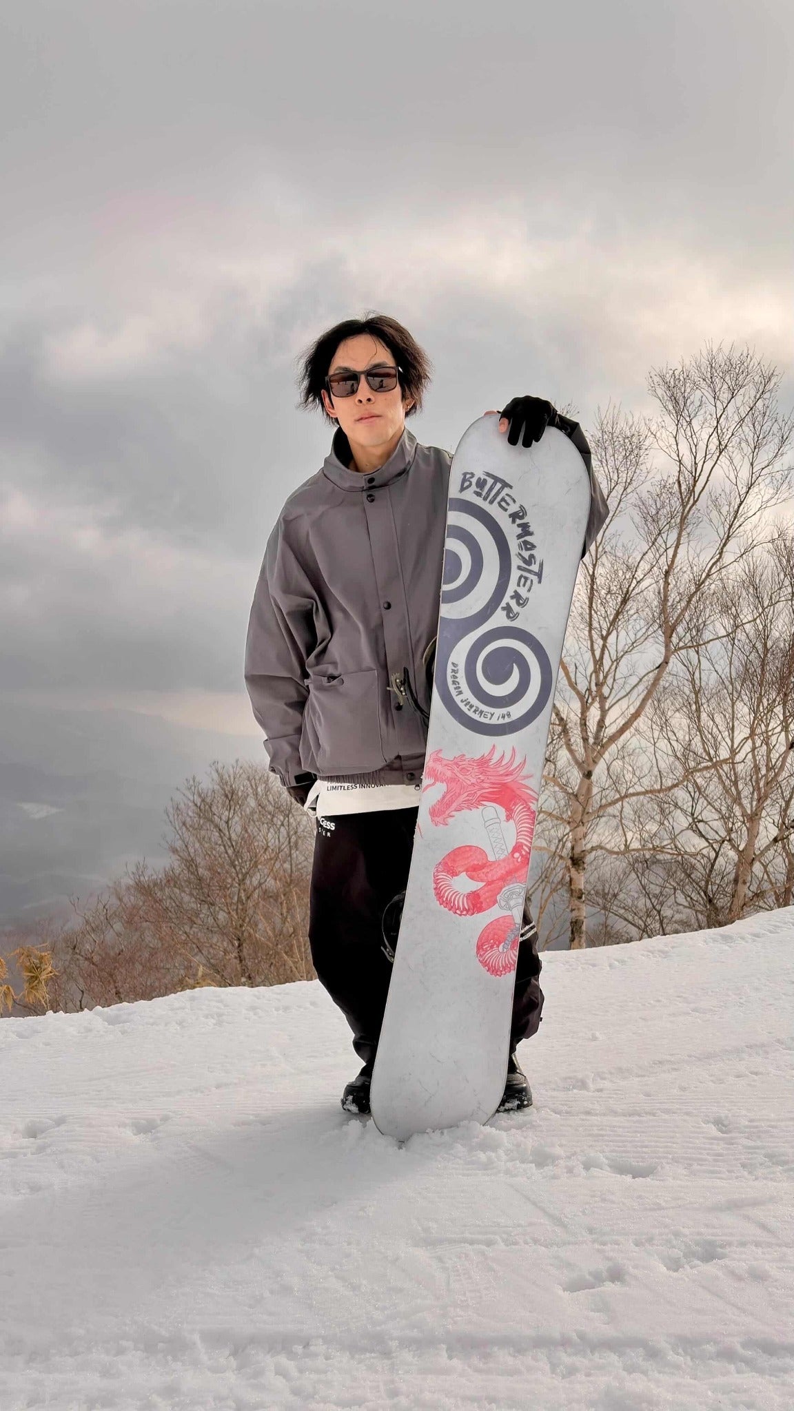 ButterMasterr rider holding Dragon Journey snowboard
